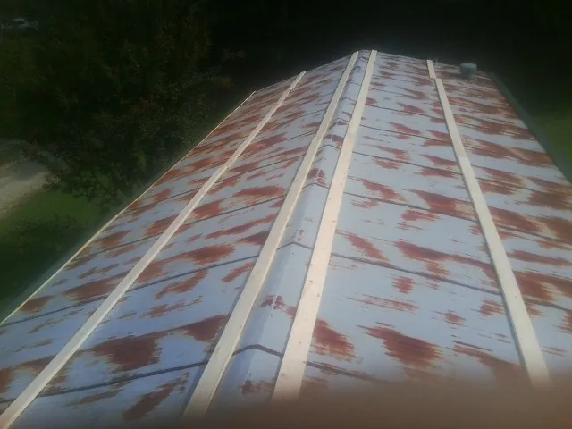Rusted metal roof panels with new wood purlins before replacement — Storm Damage Roof Repair in Potomac by Roofing Brothers